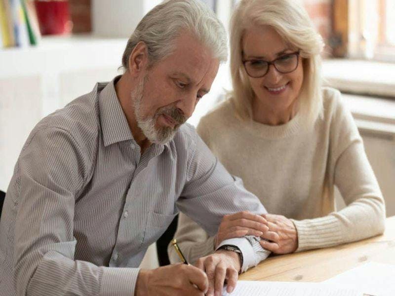 older couple signing forms