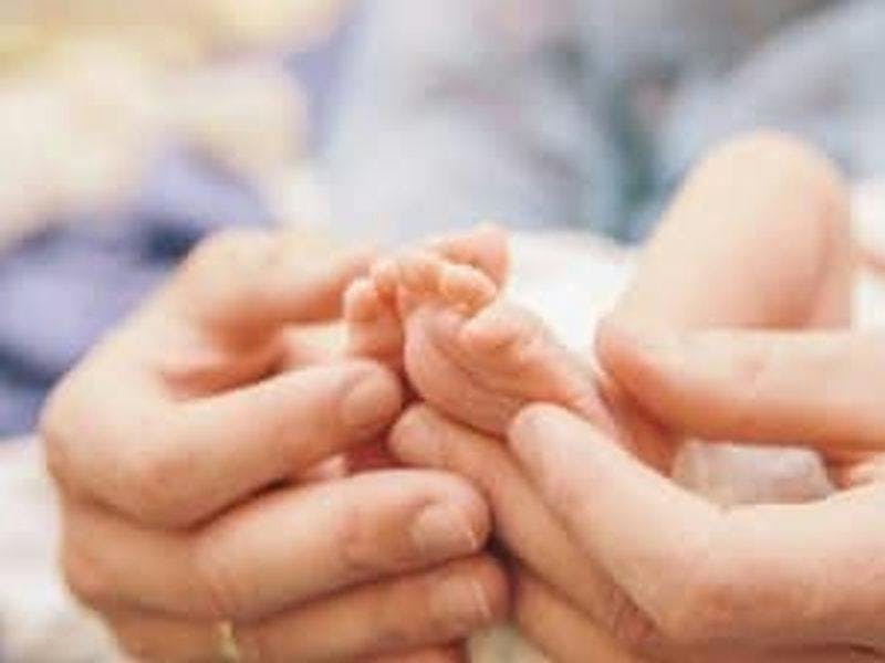 baby feet in adult hands