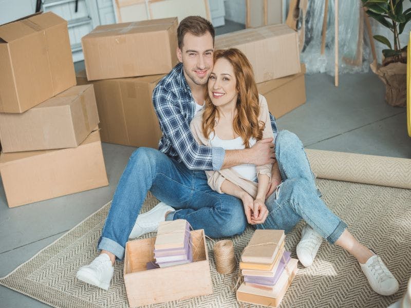 Photo of young couple packing to move home