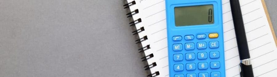 calculator, pad and pen