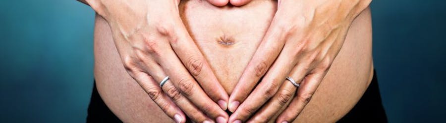 Photo of woman with hands in front of her stomach