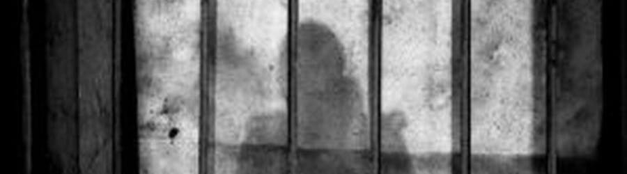 silhouette behind bars