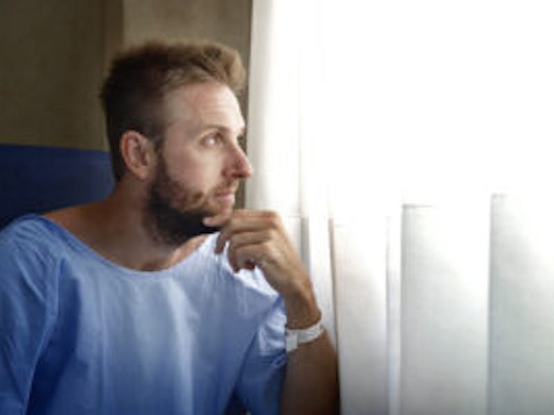 Man looking out of hospital window