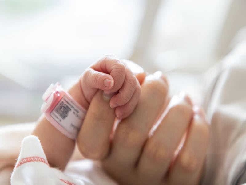 Photo of baby and mother hands