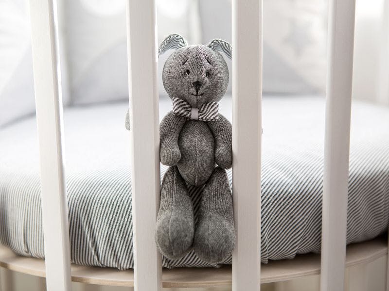 Empty cot with teddy