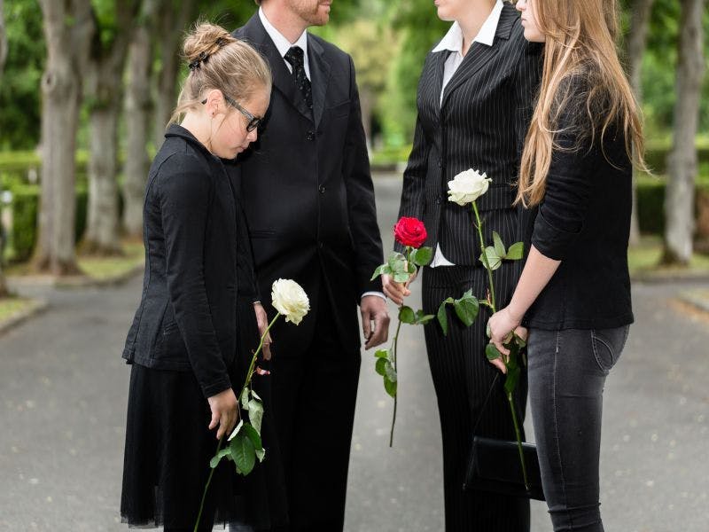 grieving family holding roses