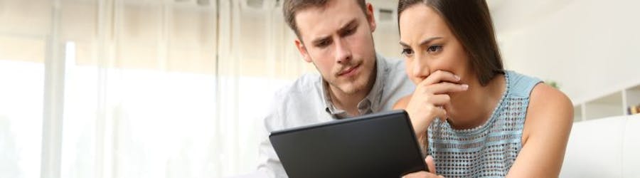 Worried couple looking at laptop