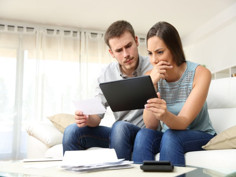 Worried  couple looking at laptop