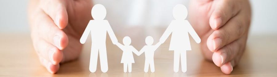 Image of hands protecting family cut-outs