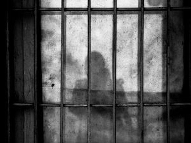 silhouette behind bars